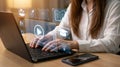 Person using laptop with online education icons and video player interface online learning Royalty Free Stock Photo