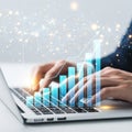 Person using a laptop with a virtual interface displaying bar graphs and charts Royalty Free Stock Photo