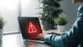 Person using laptop with warning symbol on screen Royalty Free Stock Photo