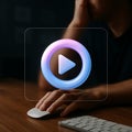 Person using mouse with glowing 3D play button icon on transparent screen video media Royalty Free Stock Photo