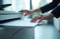 Person using office copier machine. Hand touching paper sheets, document scanning process. Business technology, paperwork, Royalty Free Stock Photo