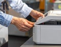 Person Using Office Printer in Business Environment Royalty Free Stock Photo