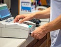 Person Using Point of Sale Terminal at Checkout Counter Royalty Free Stock Photo