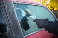 Person using a scrapper to scrape off icy and frost from the window of a red car Royalty Free Stock Photo