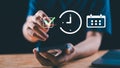 A person using a smartphone with digital icons of a check mark, clock, and calendar, symbolizing task completion, time tracking, Royalty Free Stock Photo