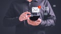 Person using a smartphone receives a new email notification, highlighting the email and internet communication.