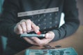 A person is using a smartphone with a virtual calendar and a red circle marking the 30th day. Royalty Free Stock Photo