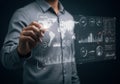 Person using stylus on digital interface displaying data analysis and world map Royalty Free Stock Photo