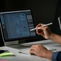 A person is using a stylus pen to interact with a touchscreen desktop computer. Royalty Free Stock Photo