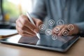 Person using stylus on tablet with digital icons representing communication and technology concepts Royalty Free Stock Photo