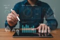 Person using stylus on tablet displaying financial charts and data analytics insights Royalty Free Stock Photo