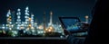 Person using tablet with data analysis industrial plant in background at night Royalty Free Stock Photo