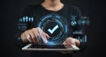 Person Using Tablet with Glowing Checkmark Hologram on Dark Background Royalty Free Stock Photo