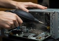 Cleaning computer hardware with air blower close up view Royalty Free Stock Photo