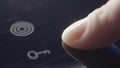 Person using touch controls on a modern glass topped hob to switch on an electric hotplate. Action. Close up of turning Royalty Free Stock Photo