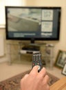 Person using TV remote control