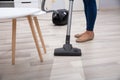 Person Using Vacuum Cleaner For Cleaning Floor Royalty Free Stock Photo