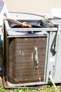 Person using water hose to clean condenser coil on air conditioner system Royalty Free Stock Photo