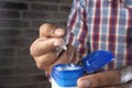 Person using white petroleum jelly, close up