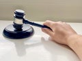 A person using Wooden Gavel with Round Block for Judge Lawyer Royalty Free Stock Photo