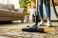 Person vacuum cleaning a colorful rug Royalty Free Stock Photo