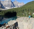 Person viewing mountains and nature form atop rock ledge