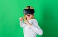 Person with virtual reality helmet isolated on green background. Woman with VR. Virtual reality experience. Royalty Free Stock Photo