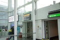 Person walking through airport hallway with signs Royalty Free Stock Photo