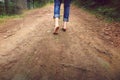 Person walking barefoot on gravel muddy road Royalty Free Stock Photo