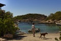 Person walking dog on Spanish beach Royalty Free Stock Photo