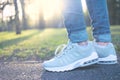 Person walking in gray running shoes, closeup Royalty Free Stock Photo