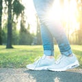 Person walking in gray running shoes, closeup Royalty Free Stock Photo