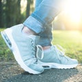 Person walking in gray running shoes, closeup Royalty Free Stock Photo