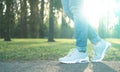 Person walking in gray running shoes, closeup Royalty Free Stock Photo