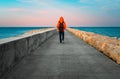 Person walking on pier at sunset Royalty Free Stock Photo
