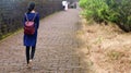 person walking on the road in a park during an evening Royalty Free Stock Photo