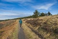 Person walking in rural countryside landscape