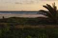 Person walking on the spanish beach at sunset on the sand next to dunes at Costa de la Luz Royalty Free Stock Photo