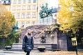 Person walking in Stockholm and old town Gamla Stan in winter or autumn. Yellow fall colors in trees and leafs. Royalty Free Stock Photo