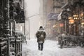 Person walking the street during a snow storm. Heavy snow in evening city Royalty Free Stock Photo