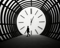 a person walking through a tunnel with a large clock Royalty Free Stock Photo