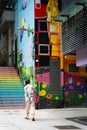 Person walking up the colorful stairs in Hong Kong