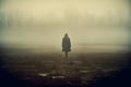 A person is walking in the woods on a foggy day. Royalty Free Stock Photo