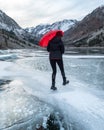 A person walks across a frozen lake Royalty Free Stock Photo