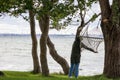 a person walks along the beach in the morning and stops by a hammock