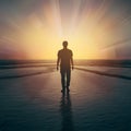 Person walks into sunrise, symbolizing hope and optimism for future