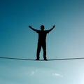 Person walks tightrope, balancing risk and opportunity with precision