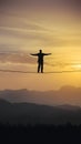 Person walks tightrope, balancing risk and opportunity with precision