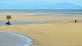 A person walks on a a wild beach in Queensland Australia Royalty Free Stock Photo