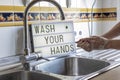 Person washing hands with a message box behind where it says wash your hands during quarantine Royalty Free Stock Photo